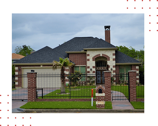 A house with a fence and gate in front of it